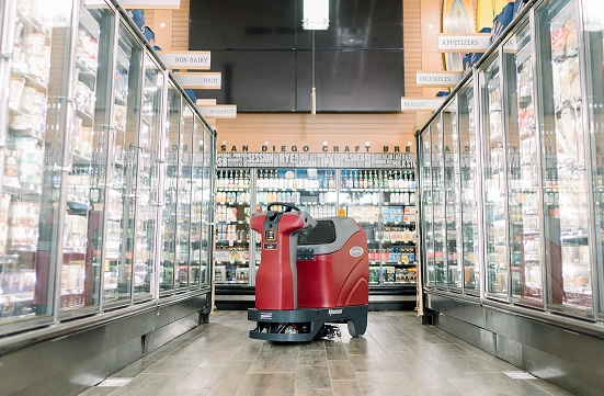 Autonomous floor scrubber in a grocery store aisle